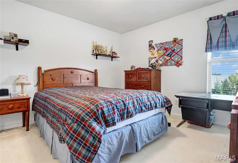 Neutral-toned room featuring wall-to-wall carpeting and a single window with slatted blinds — 2061 Avalon Mist Circle, Dardenne Prairie, MO 63368