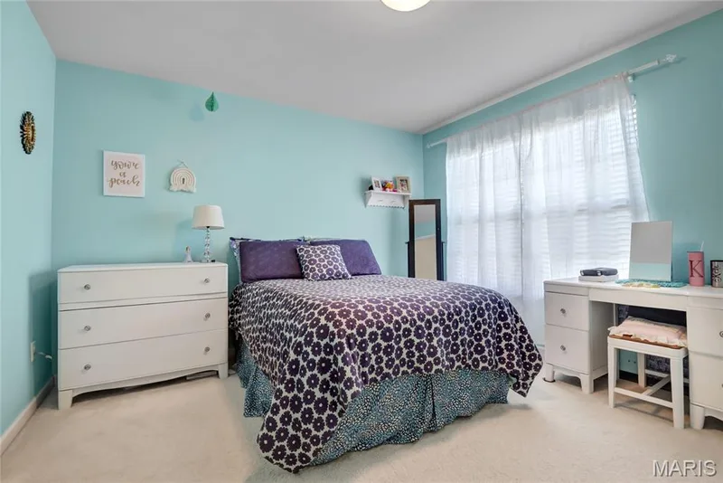 Bright room featuring plush wall-to-wall carpeting, large window with layered window treatments, and wall-mounted shelving — 2061 Avalon Mist Circle, Dardenne Prairie, MO 63368