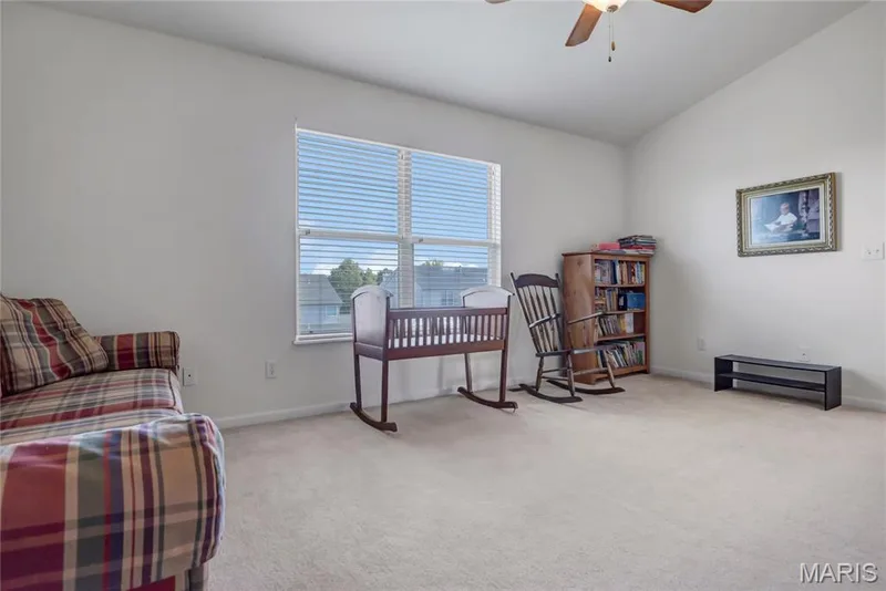 Neutral-toned room featuring high vaulted ceilings, wall-to-wall carpeting, and a ceiling fan with light fixture — 2061 Avalon Mist Circle, Dardenne Prairie, MO 63368