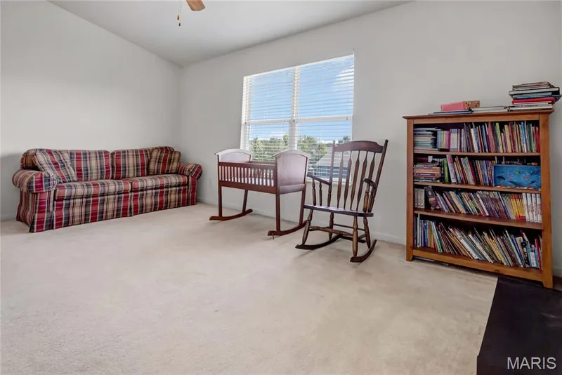 Neutral-toned interior room featuring vaulted ceilings, neutral wall-to-wall carpeting, and a multi-pane window with horizontal blinds — 2061 Avalon Mist Circle, Dardenne Prairie, MO 63368