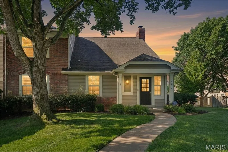 Charming residence featuring a brick and siding exterior with a covered front porch — 15826 Harris Ridge Court #15826, Chesterfield, MO 63017