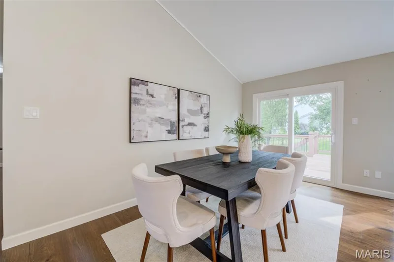 Vaulted ceilings, wood-finish flooring, sliding glass door, and a wood deck — 1094 Harness Drive, St Charles, MO 63304