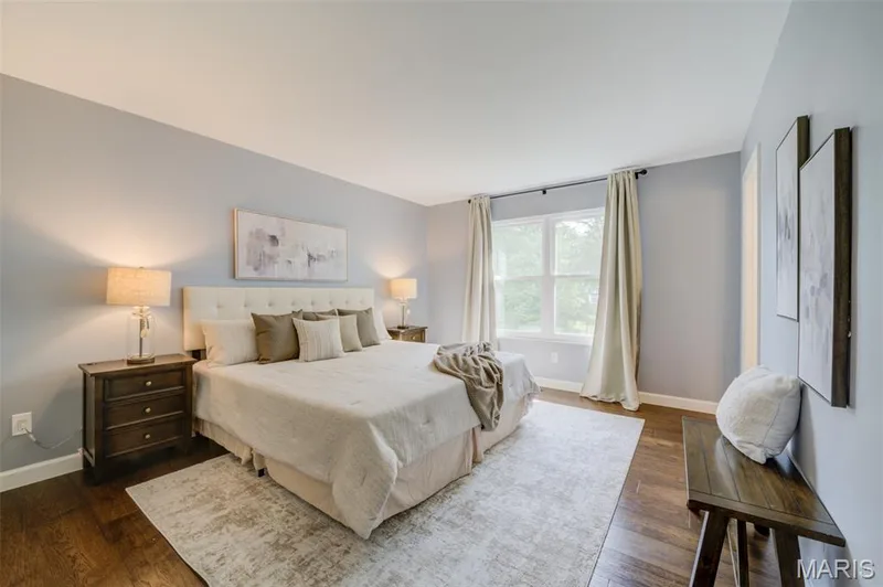 Wood-finish flooring, light grey walls, and a large window with white trim — 1094 Harness Drive, St Charles, MO 63304