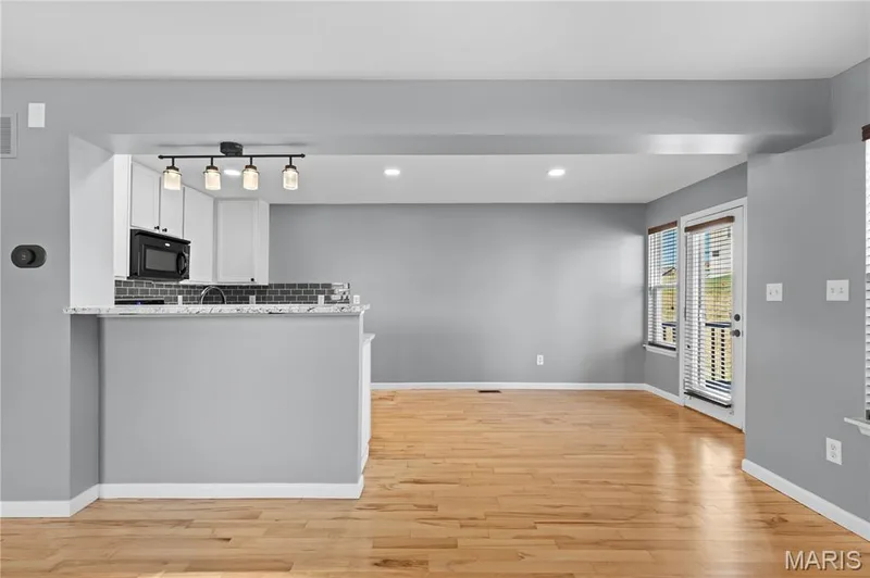 The updated Kitchen features a granite breakfast bar, the perfect spot for appetizers during the game or additional seating for entertaining! — 819 Country Field Drive, Lake St. Louis, MO 63367