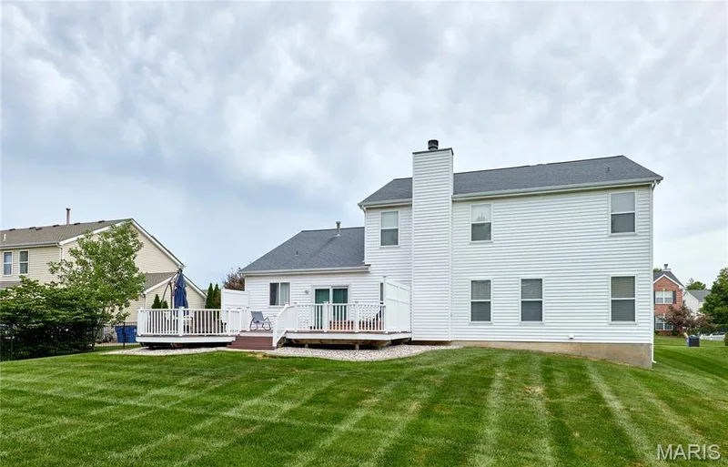 Rear of home showing a view of the expanded deck and level yard — 7428 Heathermoor Lane, Dardenne Prairie, MO 63368