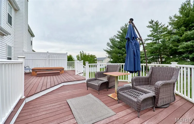 An expanded maintenance free deck just off the breakfast room provides a peaceful place to enjoy your morning cofee or just relax in the evening while you watch your children or pets play in the large level back yard — 7428 Heathermoor Lane, Dardenne Prairie, MO 63368