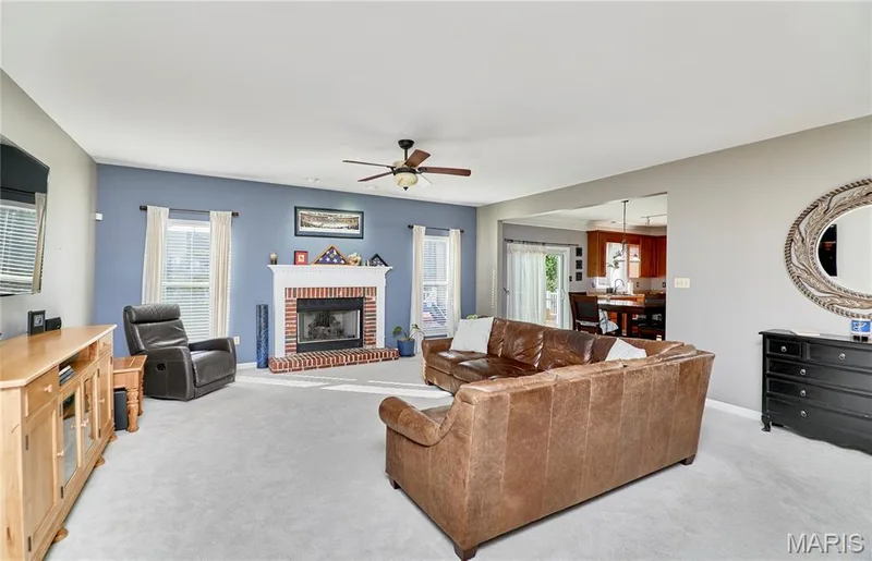 Spacious Great Room is light & bright featuring a gas fireplace with brick surround and ornate mantle — 7428 Heathermoor Lane, Dardenne Prairie, MO 63368