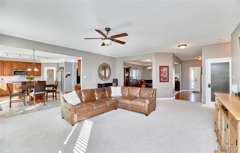 Great Room opens into a breakfast room with access to an expanded maintenance free deck and kitchen — 7428 Heathermoor Lane, Dardenne Prairie, MO 63368
