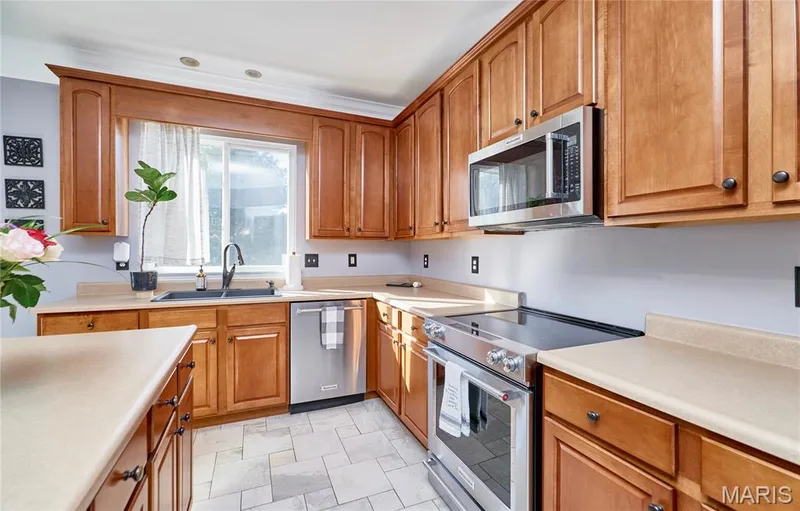 The kitchen offers an abundance of wood cabinetry & countertop space throughout — 7428 Heathermoor Lane, Dardenne Prairie, MO 63368