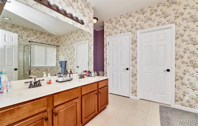Primary Bathroom features dual sinks, water closet, separate shower, large soaking tub and access to a HUGE walk in closet — 7428 Heathermoor Lane, Dardenne Prairie, MO 63368