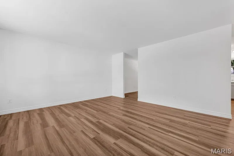 Living Room with new flooring, fresh paint, and new baseboards — 15 Country Hill Road, St Peters, MO 63376