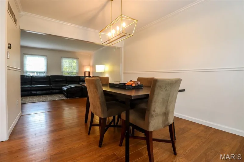 Dining room opens to living room with wood flooring — 2502 Forest Leaf Parkway, Wildwood, MO 63011