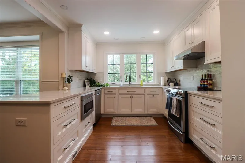 Stainless steel applianced, corian countertops and wood flooring — 2502 Forest Leaf Parkway, Wildwood, MO 63011