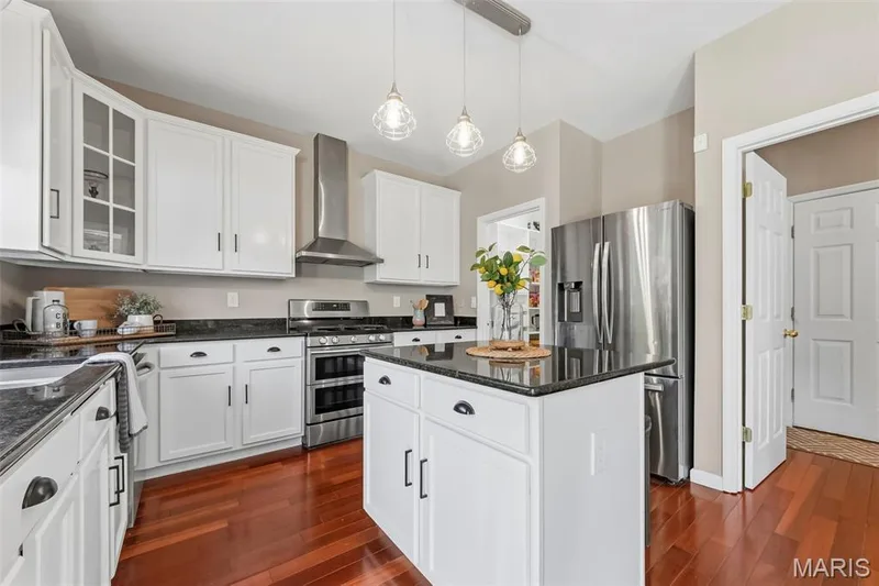 42' cabinetry in kitchen with stainless hood over gas range — 106 Crimson Oaks Court, Lake St. Louis, MO 63367