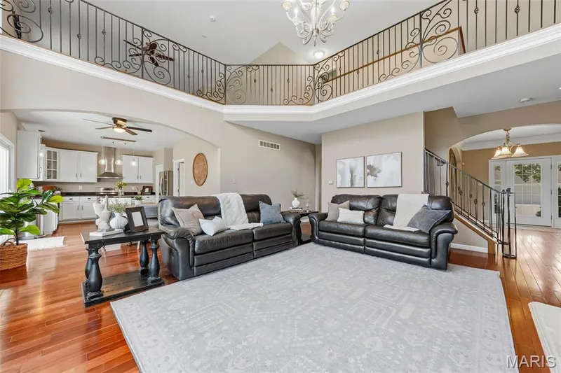 18 ft ceiling in Great room showing off custom wrought iron spindles in the loft area — 106 Crimson Oaks Court, Lake St. Louis, MO 63367