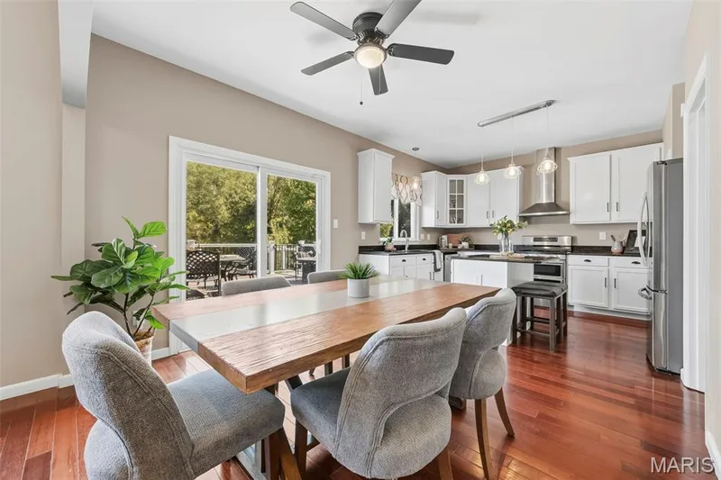 Updated light fixtures in kitchen as well as newer sliding glass door opening to deck — 106 Crimson Oaks Court, Lake St. Louis, MO 63367