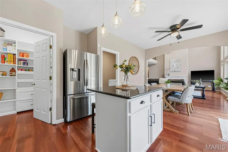 Custom Closet Co. pantry with built in drawers & shelving along with center island/breakfast bar — 106 Crimson Oaks Court, Lake St. Louis, MO 63367