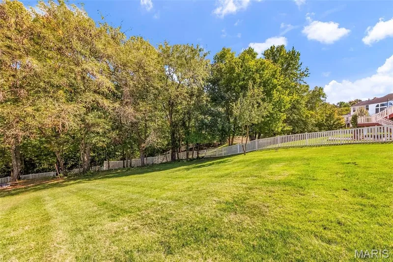 This 1/2 acre lot gives you plenty of room to roam, relax, and take in the serene wooded backdrop! — 106 Crimson Oaks Court, Lake St. Louis, MO 63367