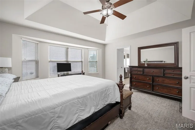 Vaulted tray ceiling, bay window configuration, and central ceiling fan with integrated lighting — 757 Lost Canyon Boulevard, Wentzville, MO 63385