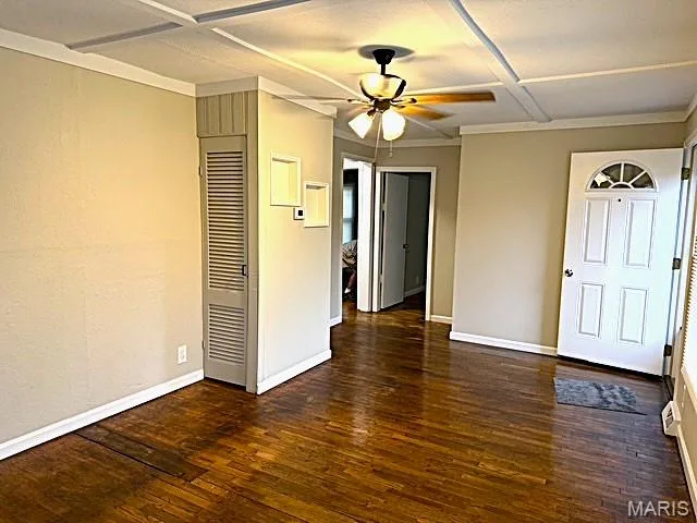 Interior space featuring wood-finish flooring, a coffered ceiling, a ceiling fan with integrated lighting, a built-in closet with louvered doors, and a six-panel front door with a half-moon window — 529 Emmons Avenue, St Charles, MO 63301