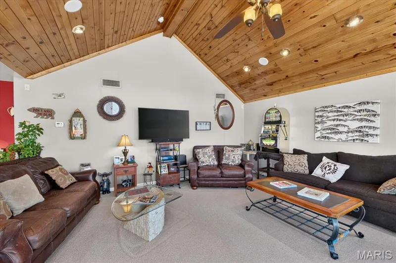 Vaulted wood-plank ceiling featuring integrated recessed lighting and a central ceiling fan — 69 Weule Boat Harbor, St Charles, MO 63301