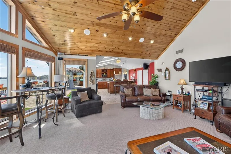 Vaulted ceilings with exposed wood paneling, large windows, recessed lighting, and a ceiling fan — 69 Weule Boat Harbor, St Charles, MO 63301