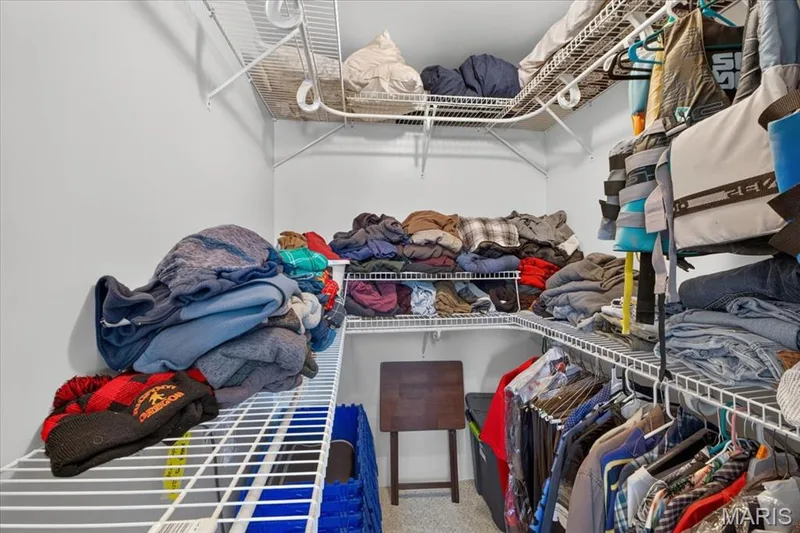 Walk-in closet featuring multi-tiered white wire shelving — 69 Weule Boat Harbor, St Charles, MO 63301