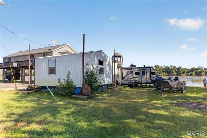 Waterfront property featuring a grassy lot with direct water access — 69 Weule Boat Harbor, St Charles, MO 63301