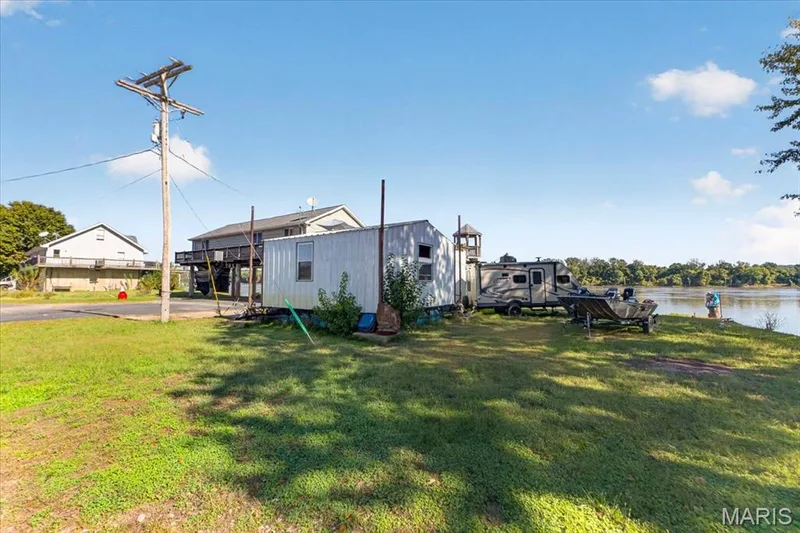 Waterfront property featuring natural grass grounds and direct shoreline access — 69 Weule Boat Harbor, St Charles, MO 63301