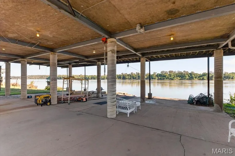 Covered concrete patio featuring structural steel beams and reinforced concrete support columns — 69 Weule Boat Harbor, St Charles, MO 63301