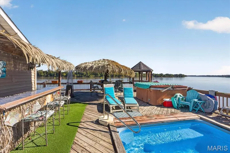 Multi-level wood deck featuring a built-in outdoor bar, recessed swimming pool with metal handrail, hot tub, and a detached gazebo — 69 Weule Boat Harbor, St Charles, MO 63301