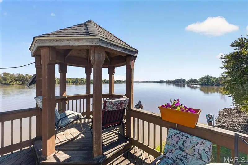 Hexagonal wooden gazebo featuring a shingled roof, attached wooden railing, and a raised wooden deck platform — 69 Weule Boat Harbor, St Charles, MO 63301