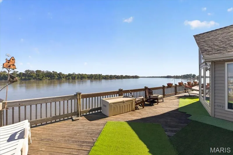 Expansive wood-plank deck featuring a wooden railing and direct water frontage — 69 Weule Boat Harbor, St Charles, MO 63301