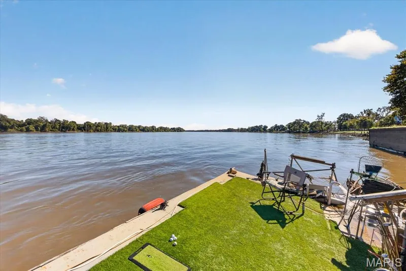 Waterfront property featuring a concrete bulkhead and a synthetic turf-covered dock — 69 Weule Boat Harbor, St Charles, MO 63301