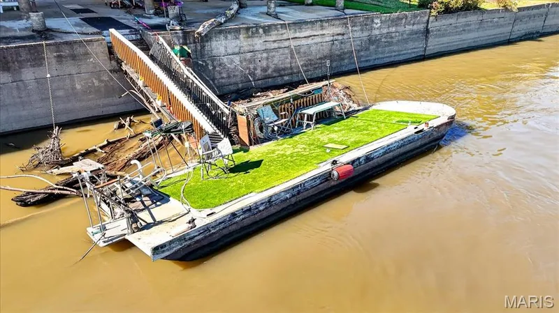 Waterfront bulkhead featuring a metal staircase and a floating barge platform with synthetic turf surfacing — 69 Weule Boat Harbor, St Charles, MO 63301