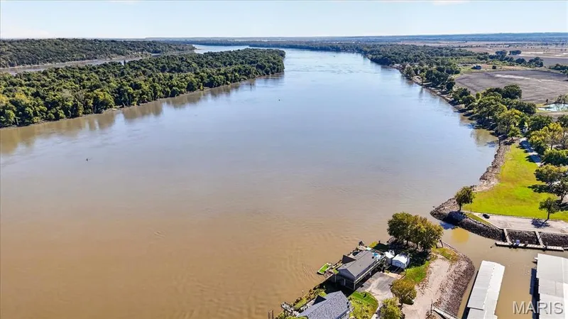 Aerial perspective featuring direct river frontage, deep-water boat docks, and expansive natural scenery — 69 Weule Boat Harbor, St Charles, MO 63301