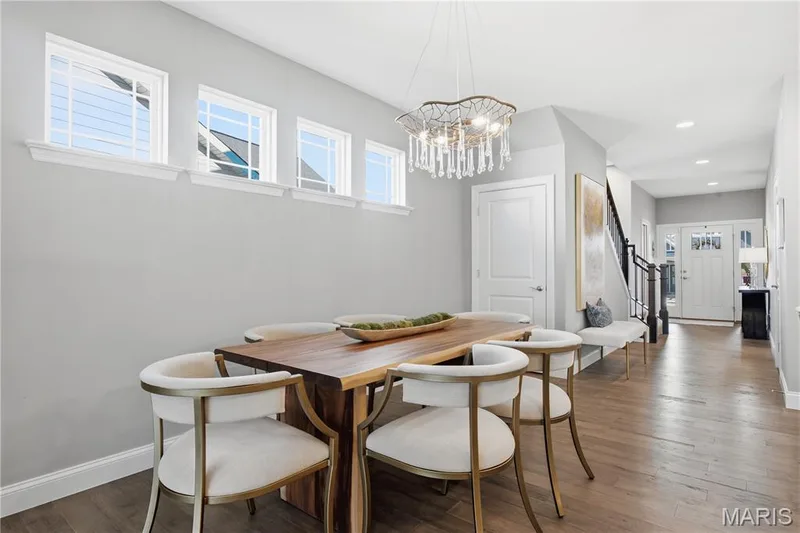 Wood-finish flooring, recessed lighting, decorative chandelier, transom windows, and solid-core interior doors — 17028 Fire Glow Drive, Wildwood, MO 63011