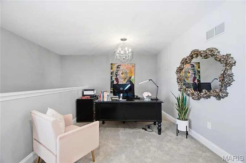 Neutral-toned room featuring wall-to-wall carpeting and a contemporary spherical chandelier — 17028 Fire Glow Drive, Wildwood, MO 63011