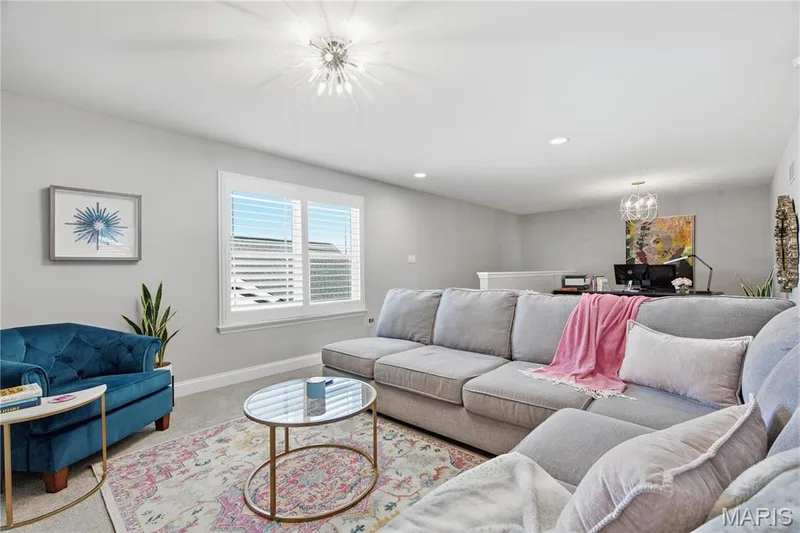 Interior space featuring recessed lighting, a modern sunburst-style chandelier, and plantation shutters — 17028 Fire Glow Drive, Wildwood, MO 63011