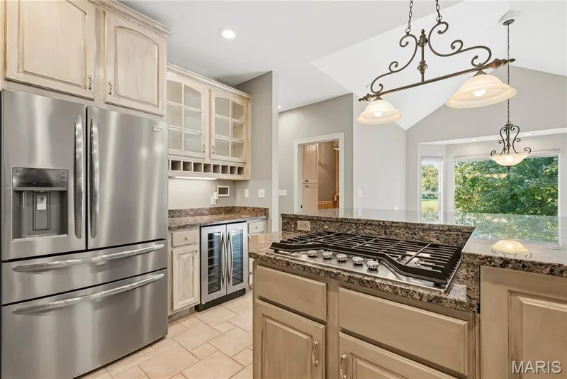Kitchen with gas cooktop, wine fridge, center island — 2221 Blue Lake Drive, Wentzville, MO 63385