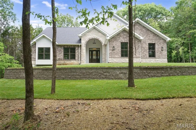 Optional Elevation with Stone Arch. Photo of Previously Built Home. — Sycamore-Ests @ Schaper Farms, Foristell, MO 63348