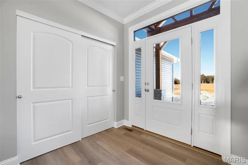 Entry foyer with glass front doors, side lites and transoms. (Photo of previously built Sycamore - upgrades may be shown) — Sycamore-Ests @ Schaper Farms, Foristell, MO 63348