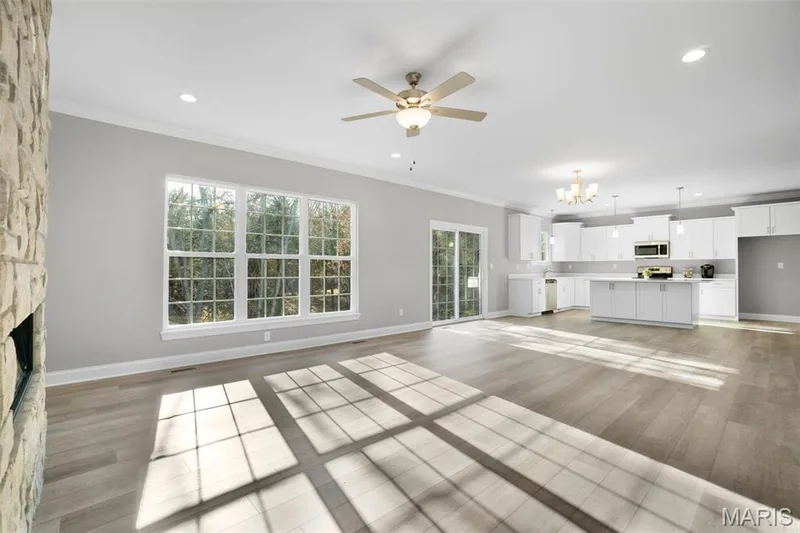 Sycamore great room shown with lvp waterproof flooring.. (Photo of previously built Sycamore - upgrades may be shown) — Sycamore-Ests @ Schaper Farms, Foristell, MO 63348