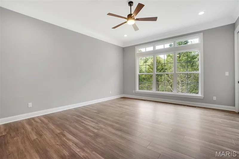 Primary bedroom with transoms, 10 ft ceiling, 3 pc crown molding, additional can lighting and LVP Flooring. (Photo of previously built Sycamore - upgrades may be shown) — Sycamore-Ests @ Schaper Farms, Foristell, MO 63348