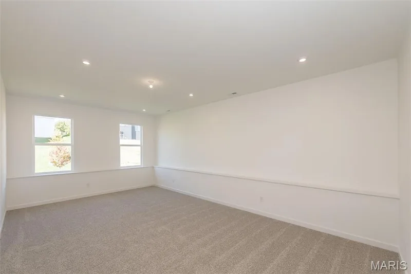 Unfurnished room featuring light colored carpet and recessed lighting — 717 Southerland Drive, O'Fallon, MO 63368