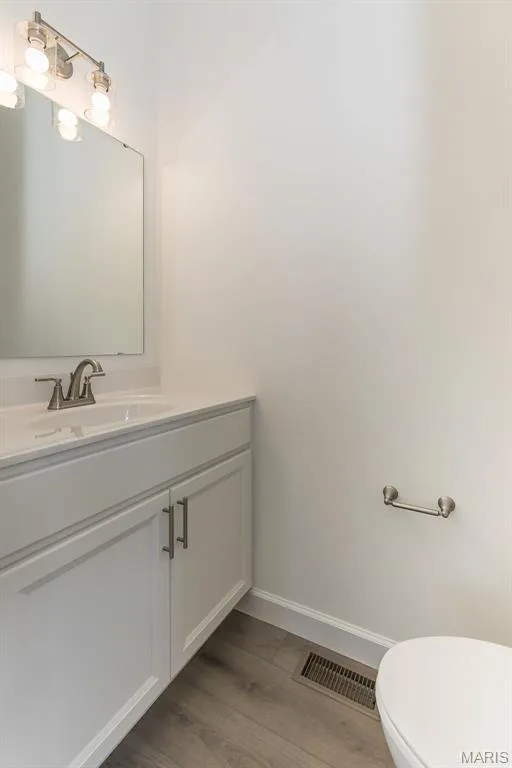 Bathroom with vanity and light wood-style floors — 717 Southerland Drive, O'Fallon, MO 63368