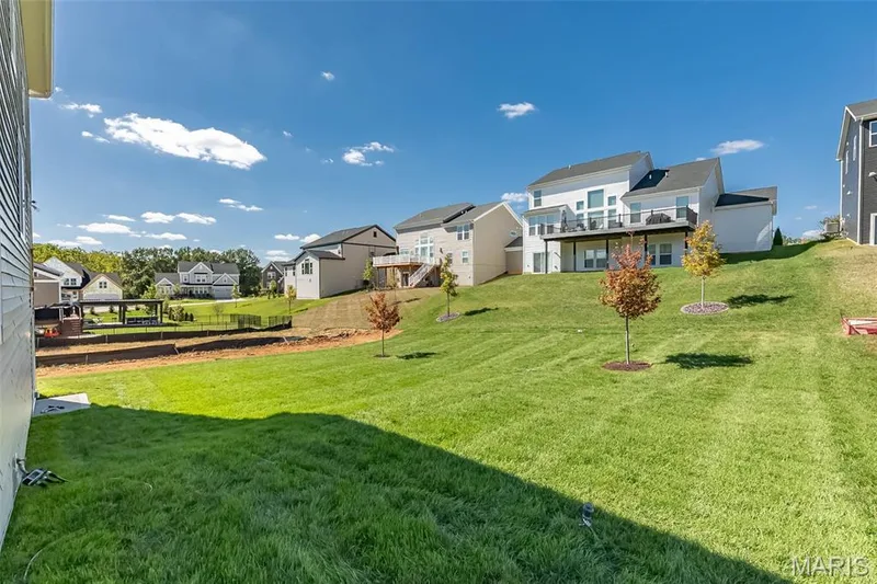 View of yard with a residential view and a balcony — 717 Southerland Drive, O'Fallon, MO 63368