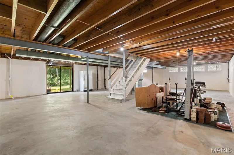 Basement is ready for updates and features a sliding walkout door. — 14336 Bramblewood Court, Chesterfield, MO 63017